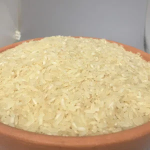 Ponni Boiled Rice - Puzungal Arisi (Bolied Rice) Close-Up Of A Clay Pot Filled With Uncooked Puzhungal Arisi Boiled Rice Health Benefits And Uses, Dm Traders Organic Store.
