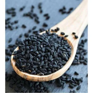 A wooden spoon filled with Karunjeeragam / black cumin seeds from DM Traders Organic store.