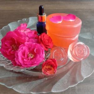 Rose Soap - Rose Soap A Glass Plate With Roses, A Small Bottle, And Two Bars Of Rose Soap From Dm Traders Organic Store.