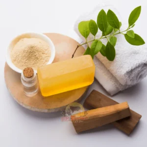 Sandalwood Soap - Sandalwood Soap A Display Of Sandalwood Soap Skincare Products Including A Soap Bar, A Bowl Of Powder, A Small Bottle, Fresh Green Leaves, Wooden Pieces, And A White Towel, Branded By Dm Traders Organic Store.